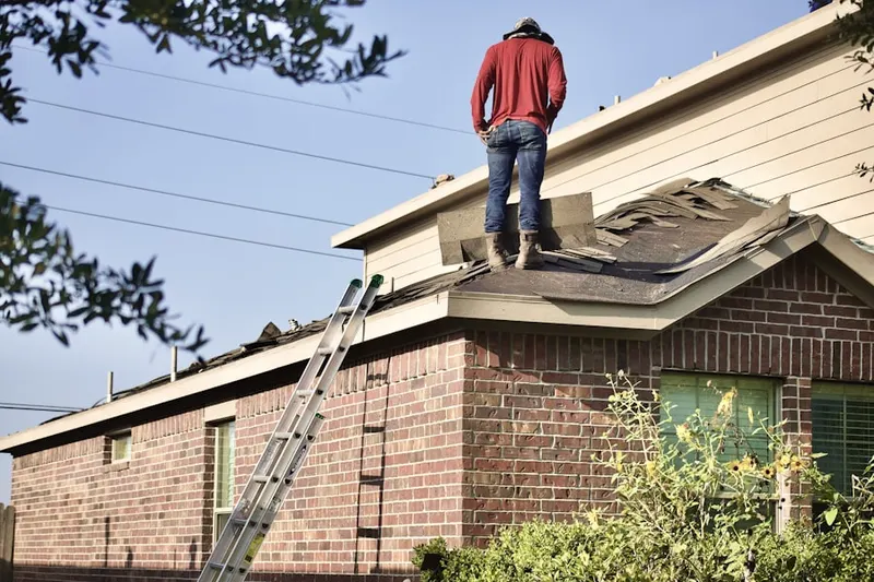 Professional roofer working on a residential roof in Pine